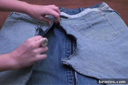 From Denim to Dream Skirt: A DIY Transformation 15 A person explaining how to make a skirt from old jeans pant, focusing on the back seam.