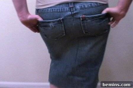 From Denim to Dream Skirt: A DIY Transformation 21 A lady wearing jeans showing her back, modeling the transformed skirt.