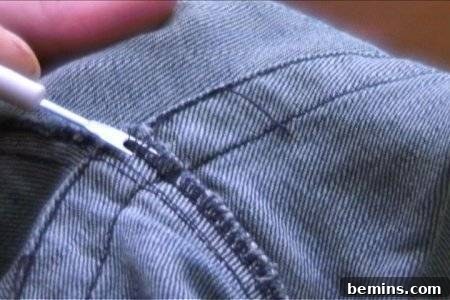 From Denim to Dream Skirt: A DIY Transformation 6 A person is explaining how to turn jeans into a skirt by ripping the seams.