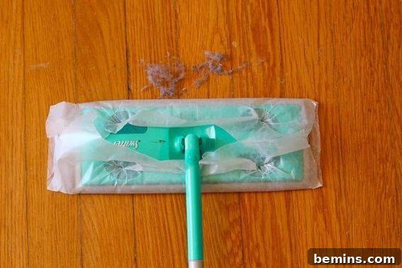 Does It Work Challenge Cleaning Floors with Wax Paper? Wax Paper Floor Cleaning The Ultimate Does It Work Test 3 Wax paper attached to Swiffer sweeper