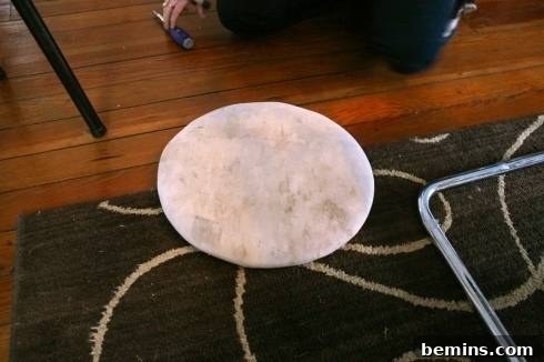Removing the seat cushion from the chair frame.