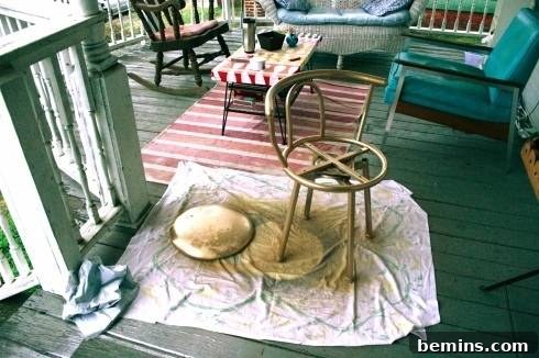 Spraying painting the chair frame gold.