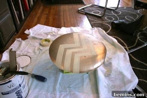 Taping off the seat cushion with masking tape to create a geometric design.