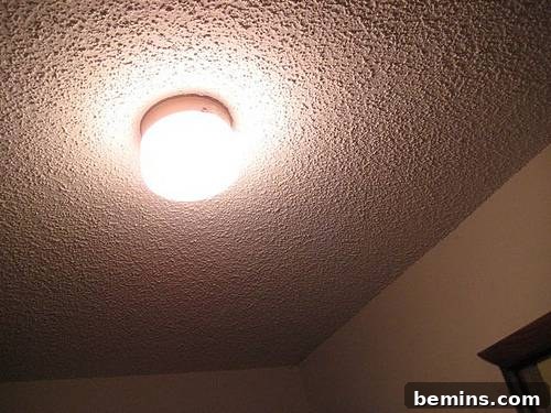 Flush ceiling light highlighting popcorn texture