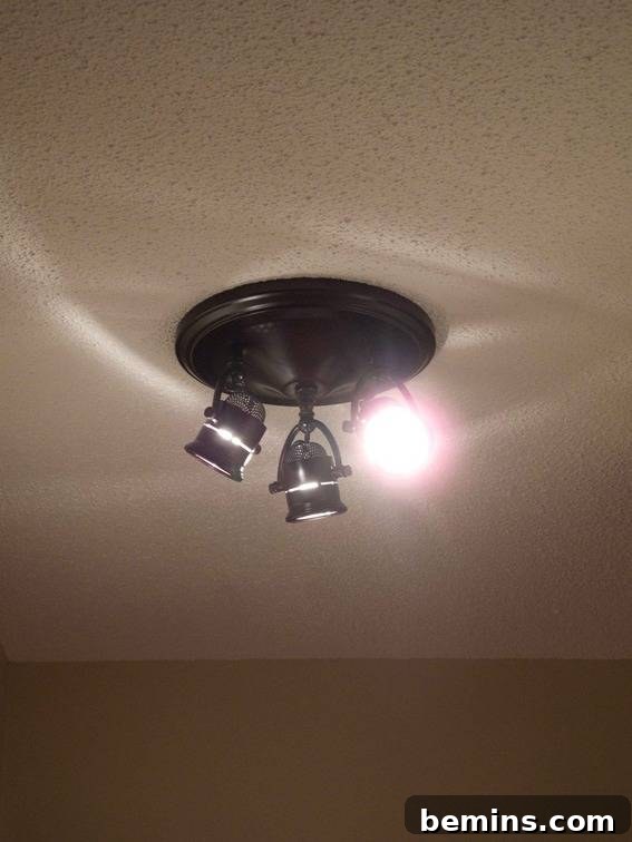 Hallway with directional lighting and popcorn ceiling
