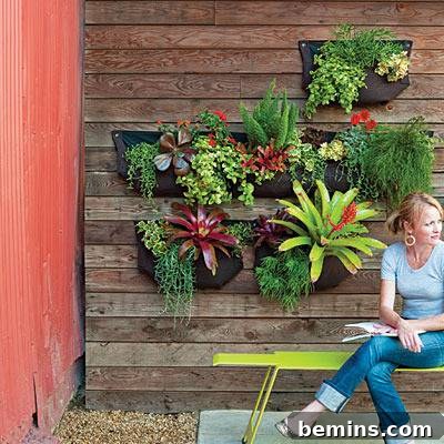 8 Ingenious DIY Garden Ideas for Compact Spaces 3 Outdoor wall adorned with a multi-pocket Woolly Pockets garden, filled with thriving green plants and flowers
