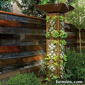 8 Ingenious DIY Garden Ideas for Compact Spaces 6 Compact multi-tiered vertical garden tower flourishing with various small edible plants like lettuce and strawberries