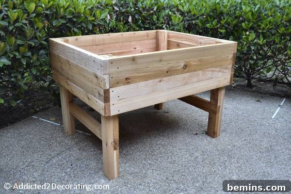 8 Ingenious DIY Garden Ideas for Compact Spaces 8 DIY wooden elevated garden bed, thoughtfully designed and filled with flourishing green plants
