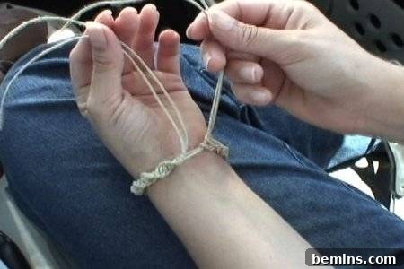 Tying hemp twine around a wrist