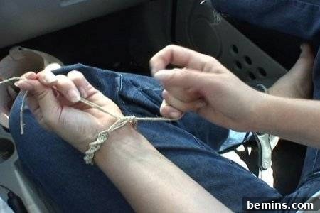 Tying hemp twine around a left wrist