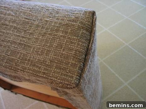 Close-up of curved upholstery needles being used to create a seamless corner