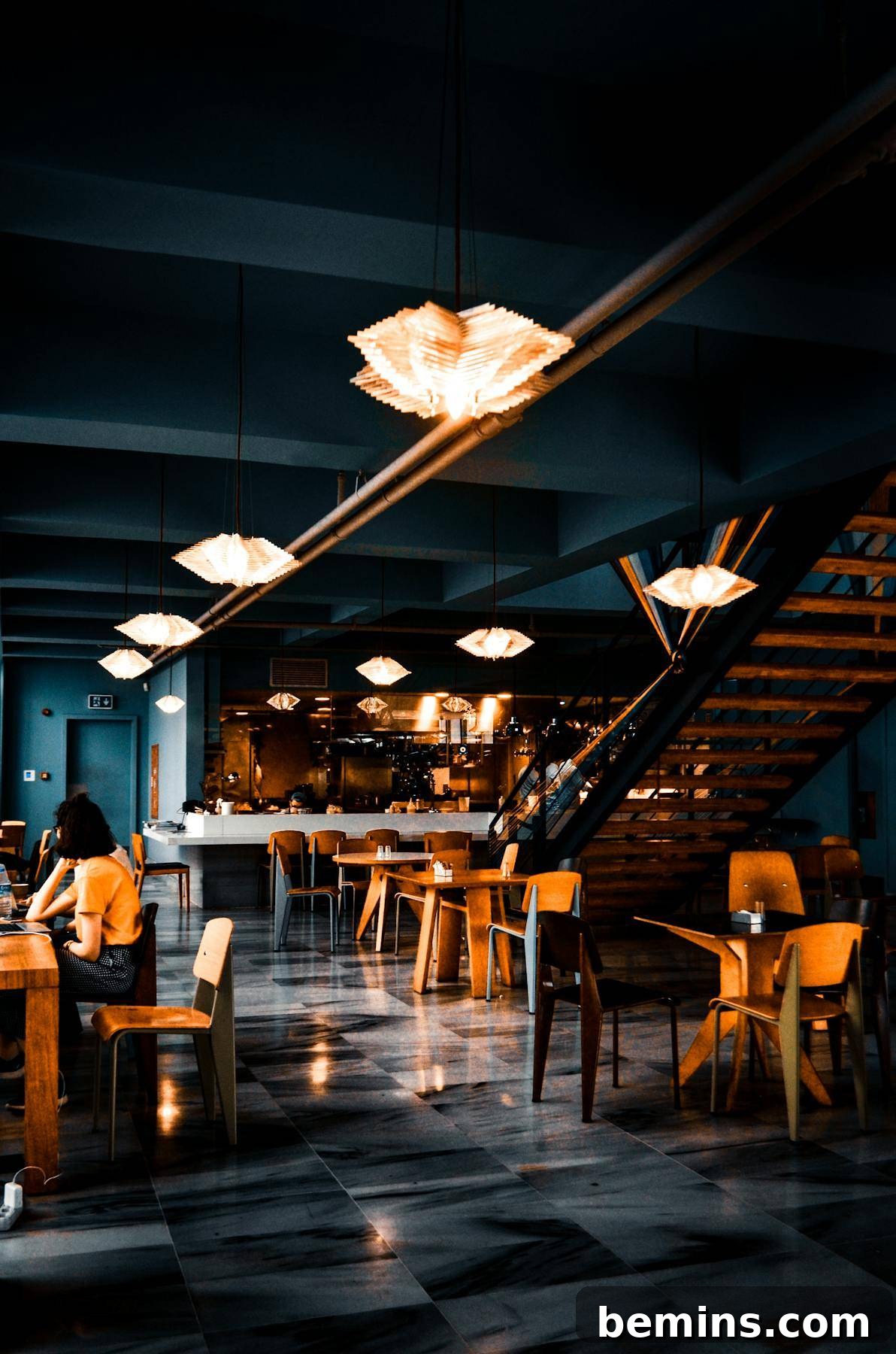 Trendy interior of cafe with creative lamps and wooden furniture with dark painted walls