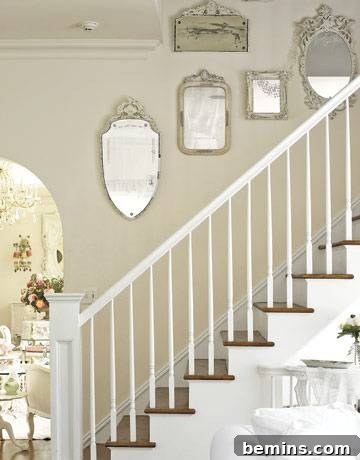 Staircase with vintage mirror gallery wall