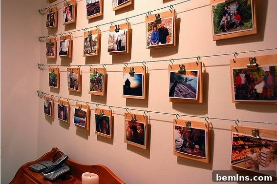 Creative DIY Photo Displays: 10 Unique Wall Art Ideas 12 Photos hanging on a wall using horizontal wires and bulldog clips.