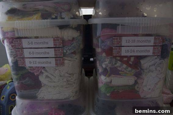 Organized bins of baby clothes, ready for moving