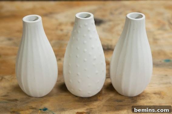 DIY Colorful Paint-Dipped Flower Vases: A Step-by-Step Guide 4 Vase being spray painted with matte white paint