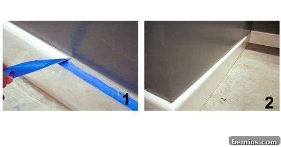 Paint Like a Pro: Insider Tips and Techniques 9 A person is pulling blue tape away from the wall.