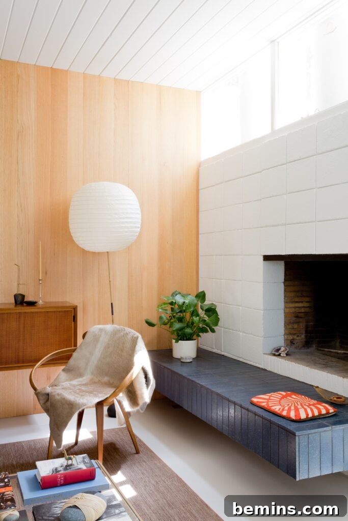 Inspired Fireplace Tile Designs for a Warm Home 14 White mid-century brick fireplace with navy blue tile seat.