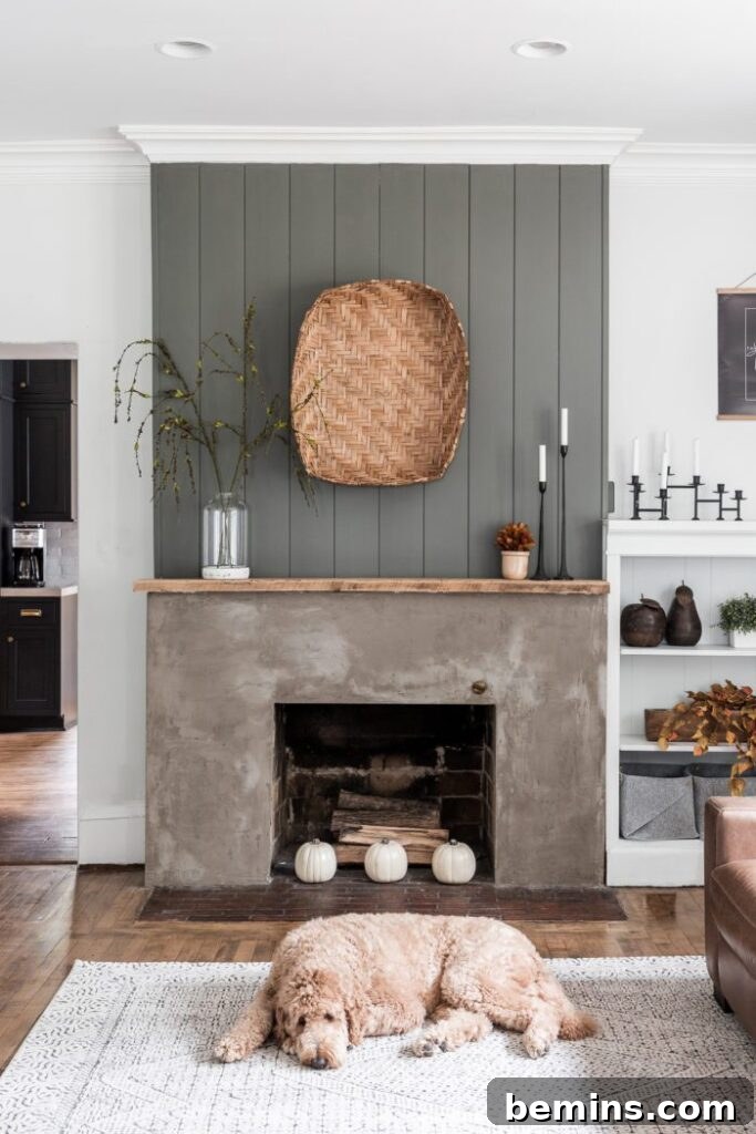 Vertical shiplap above the stucco fireplace.