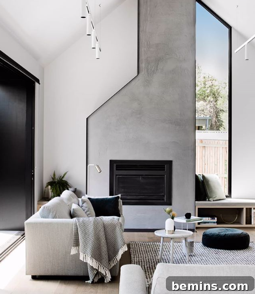 Tall modern cement fireplace and chimney.