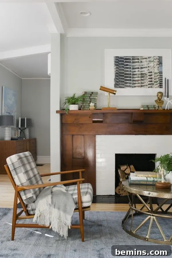 Classic craftsman fireplace with a heavy wood mantel and modern white subway tiles.