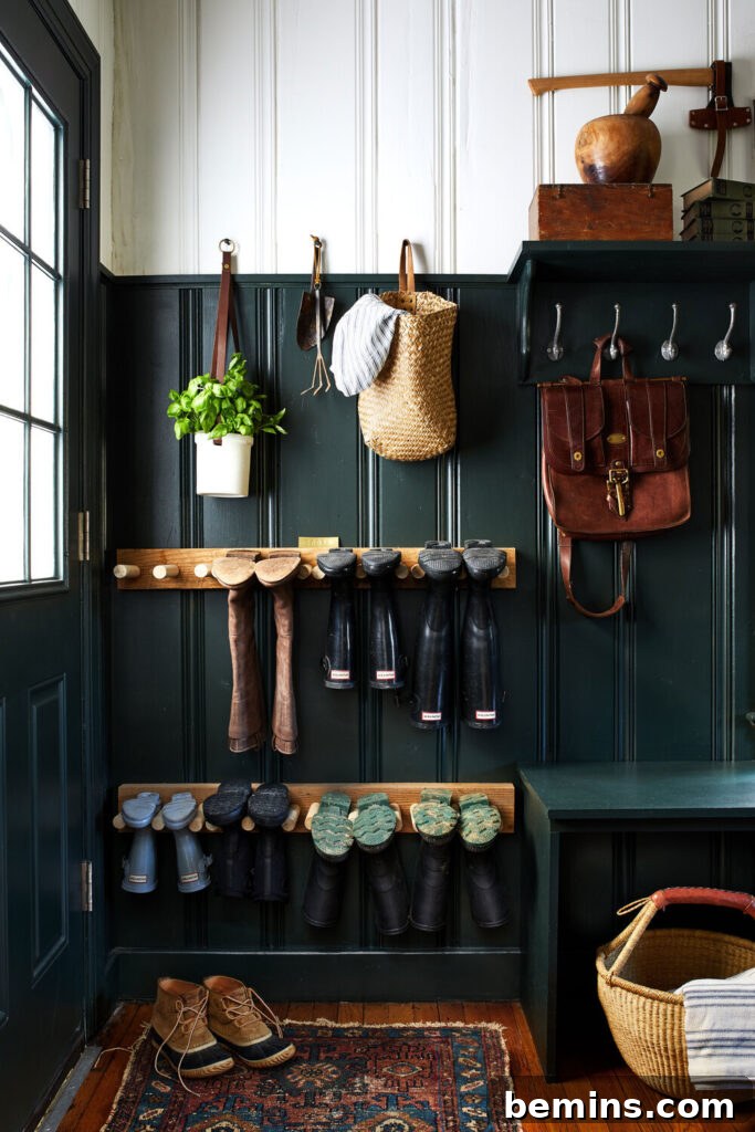 Entryway with hooks, dowels, benches, and baskets for shoe storage.
