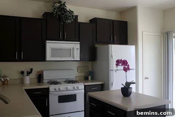 Close-up of Lauren's black cabinets with a pink orchid accent