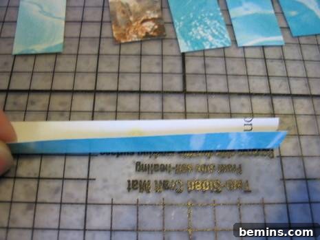 Demonstration of folding a paper strip lengthwise, creating a clean and precise crease.