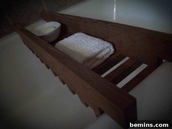 A piece of lumber sitting on top of a white bathtub.