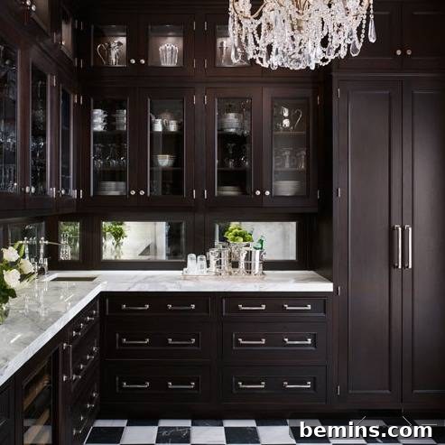 An all-white butler's pantry with a round window.