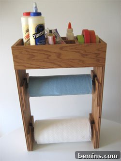 DIY paper towel dispenser sitting on a small table, holding various items.