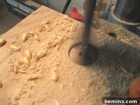 Using a power drill to create the dowel bracket holes.