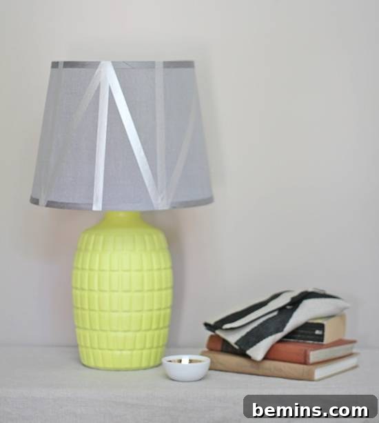 A lampshade decorated with silver washi tape.