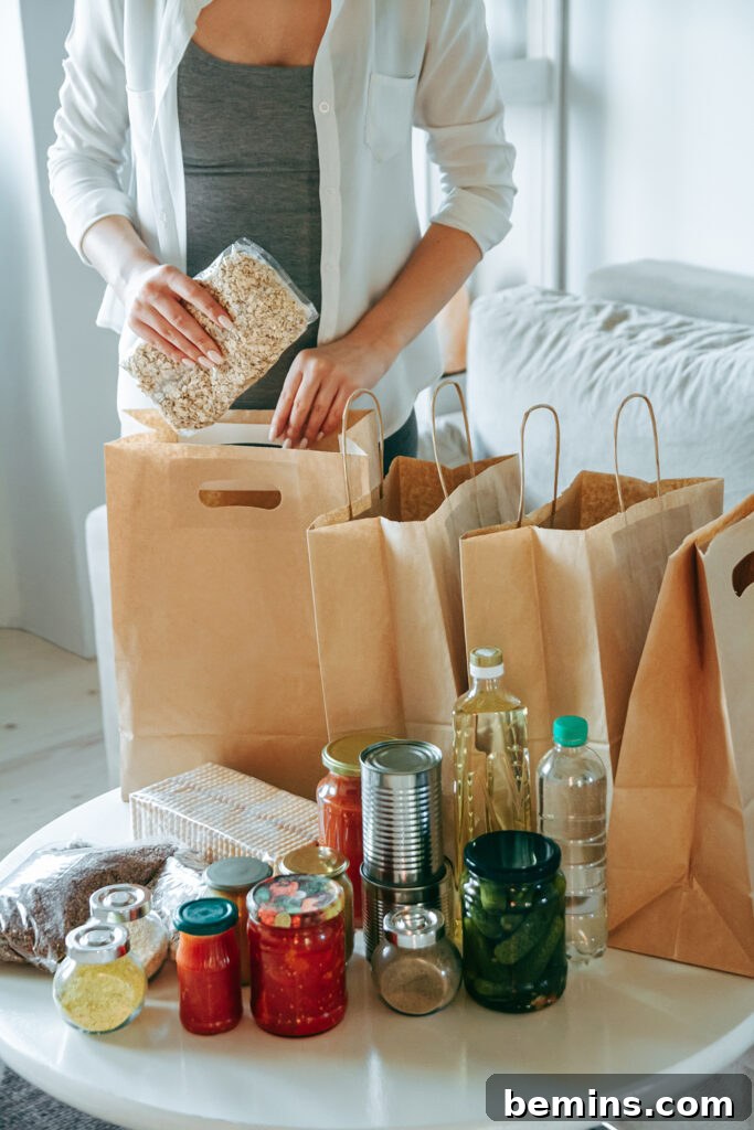 Woman packing food for donation in paper bag