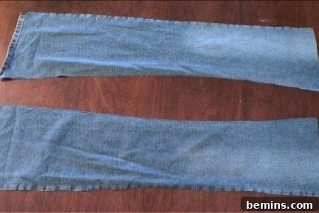 Blue jeans pant leg part cutting pieces are placed separately on the floor.