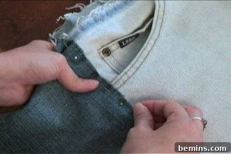 How to Sew Your Own Overalls 20 A woman holding blue colour jeans in her hand.
