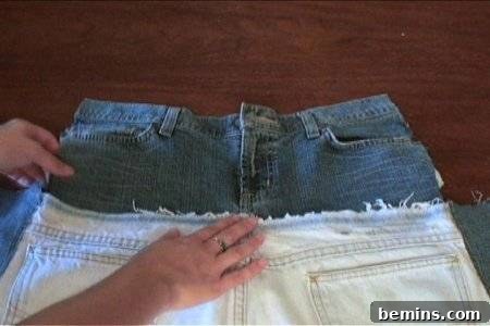 How to Sew Your Own Overalls 32 A person handling to cut pieces of blue jeans.
