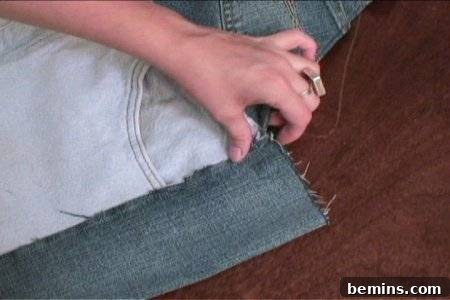 How to Sew Your Own Overalls 63 Woman covering fabric edges with another fabric for sewing.