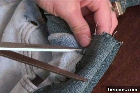 A man is cutting a cloth.