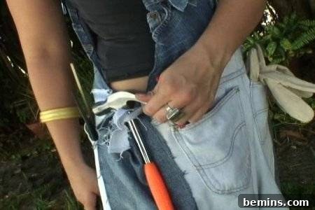 How to Sew Your Own Overalls 71 Man holding a power tool in his jeans belt with an orange handle on it.