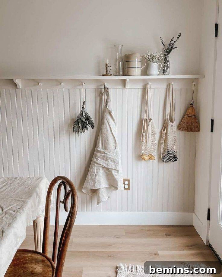 Charming Wainscoting: 21 Ways to Elevate Your Home 11 White shelf over beadboard wainscoting with purse and bags hanging