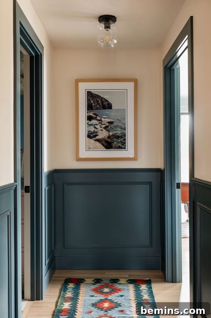 Charming Wainscoting: 21 Ways to Elevate Your Home 12 Greenish blue lower panel wainscoting in entryway with cream walls covered by framed art