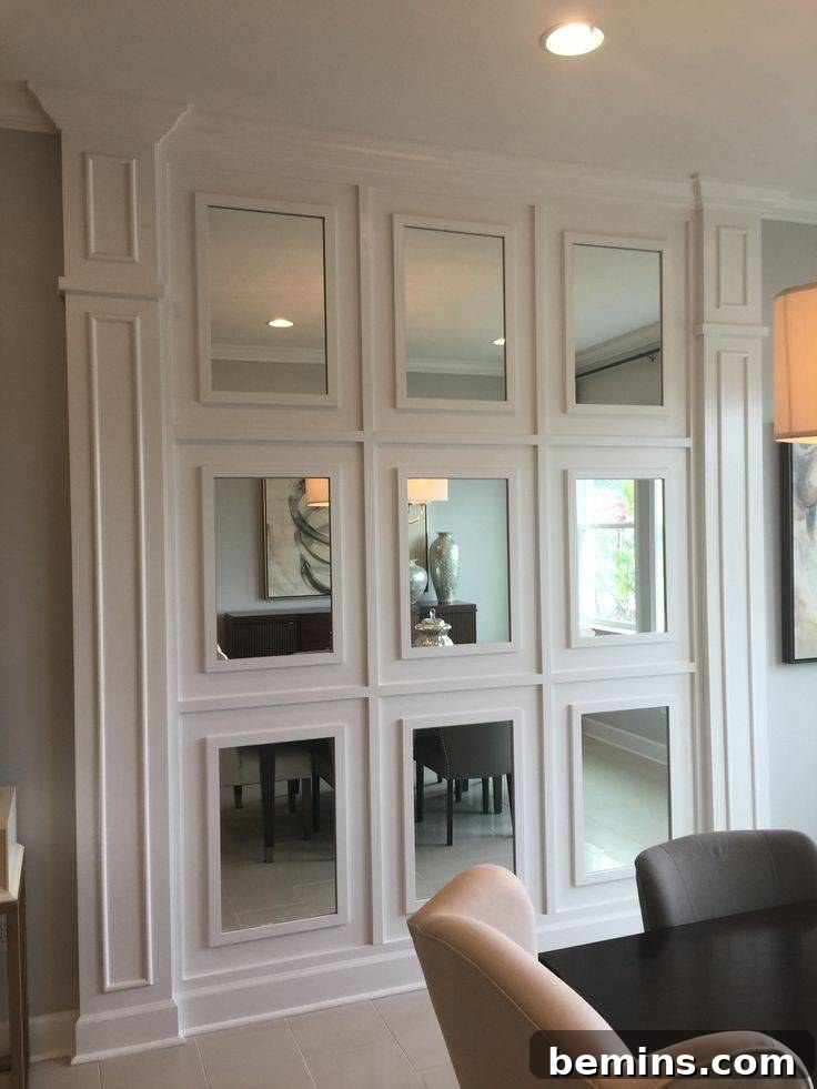 Charming Wainscoting: 21 Ways to Elevate Your Home 13 Mirrored wall with wainscoting panels behind dining room space with grey and cream chair