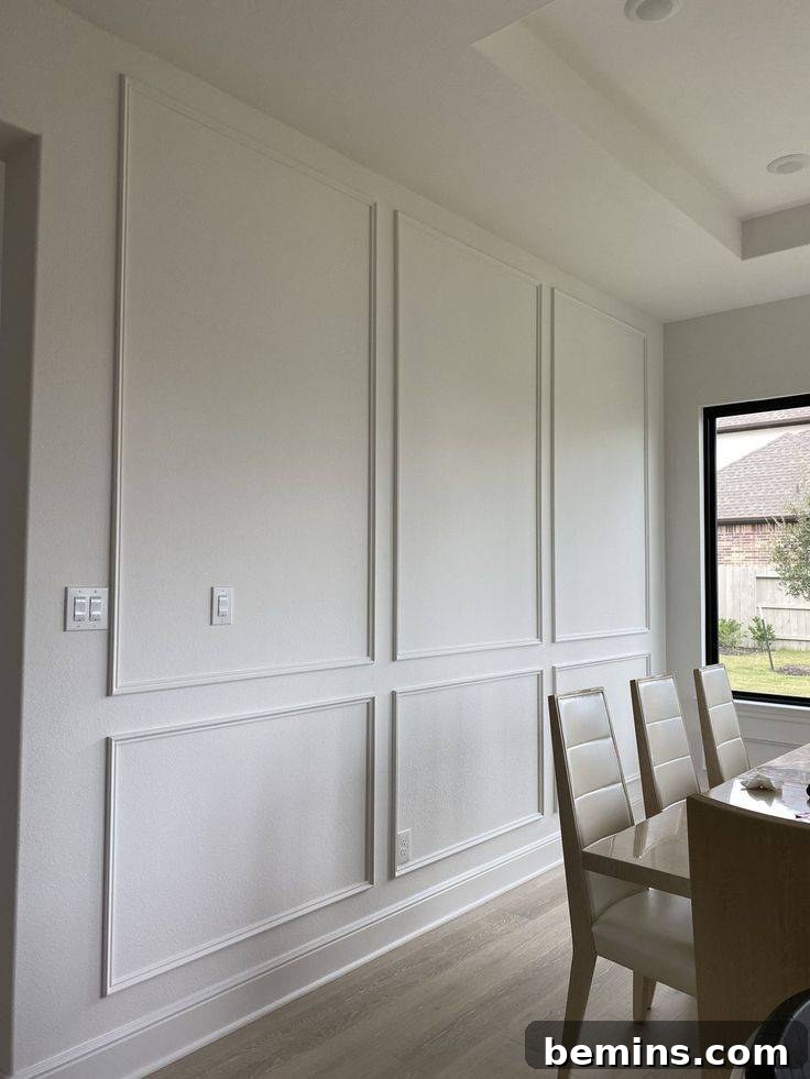 Charming Wainscoting: 21 Ways to Elevate Your Home 20 Full wall wainscoting with cream wall, brown dining table and chairs