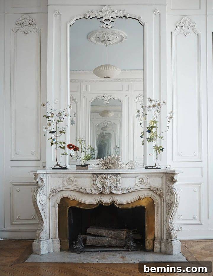 French style fireplace in white background of living room with two plants on mantle