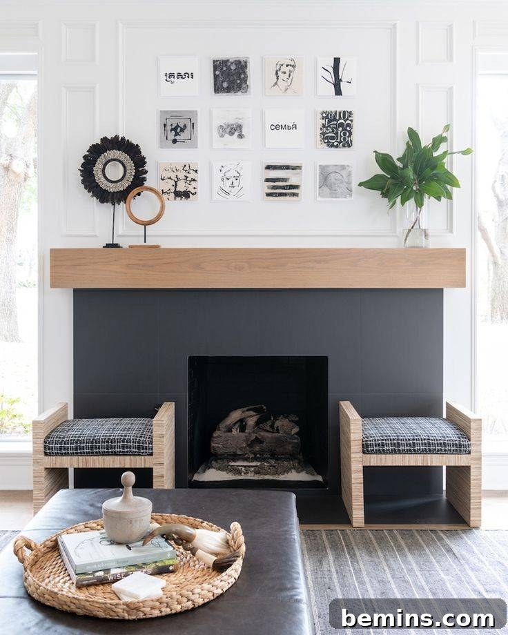 Gray painted fireplace with wood mantel and two gray chairs