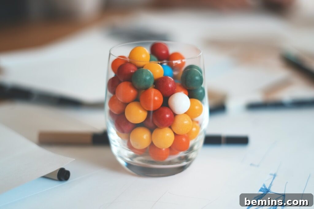 Multicolored balls in clear shot glass