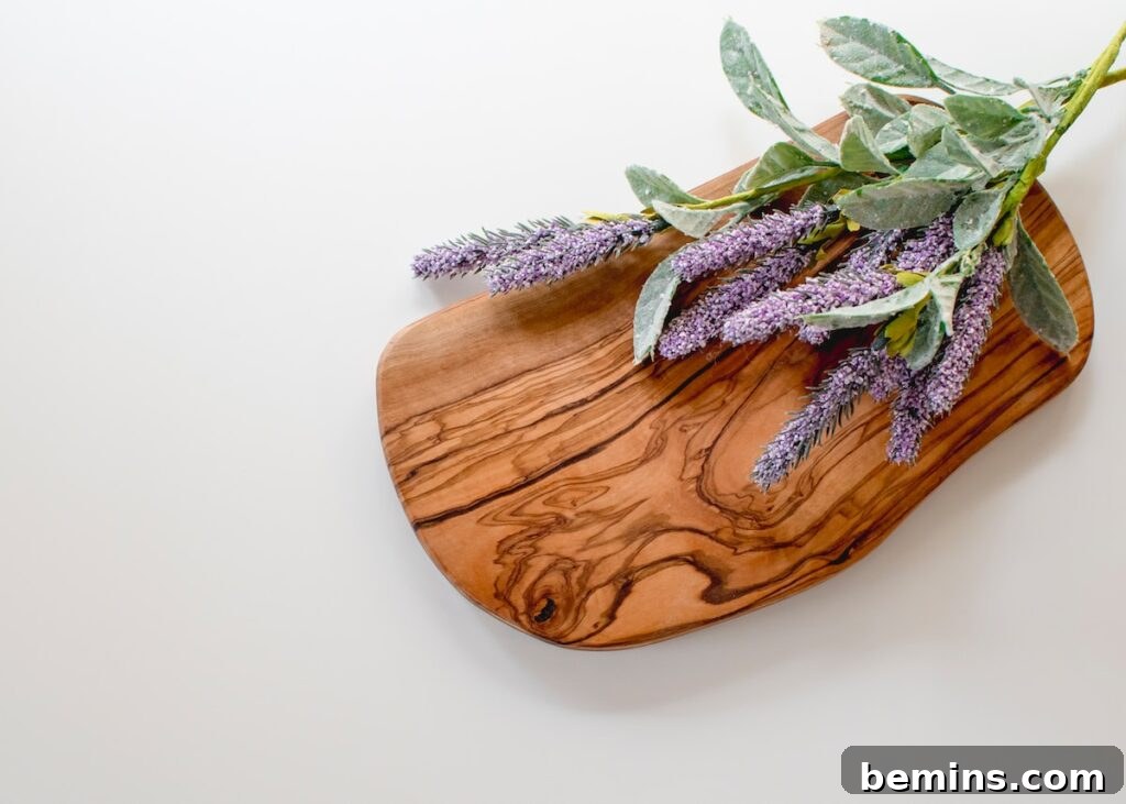 Green and purple leaves on brown wooden chopping board
