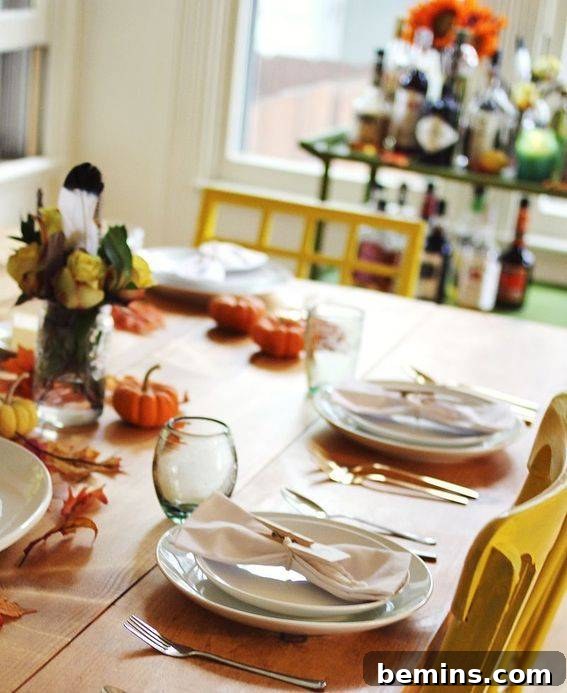 Simply decorated Friendsgiving dinner table with a cozy and inviting ambiance.
