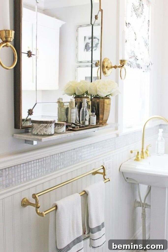 Cream wall in bathroom with mosaic wainscoting tile over sink